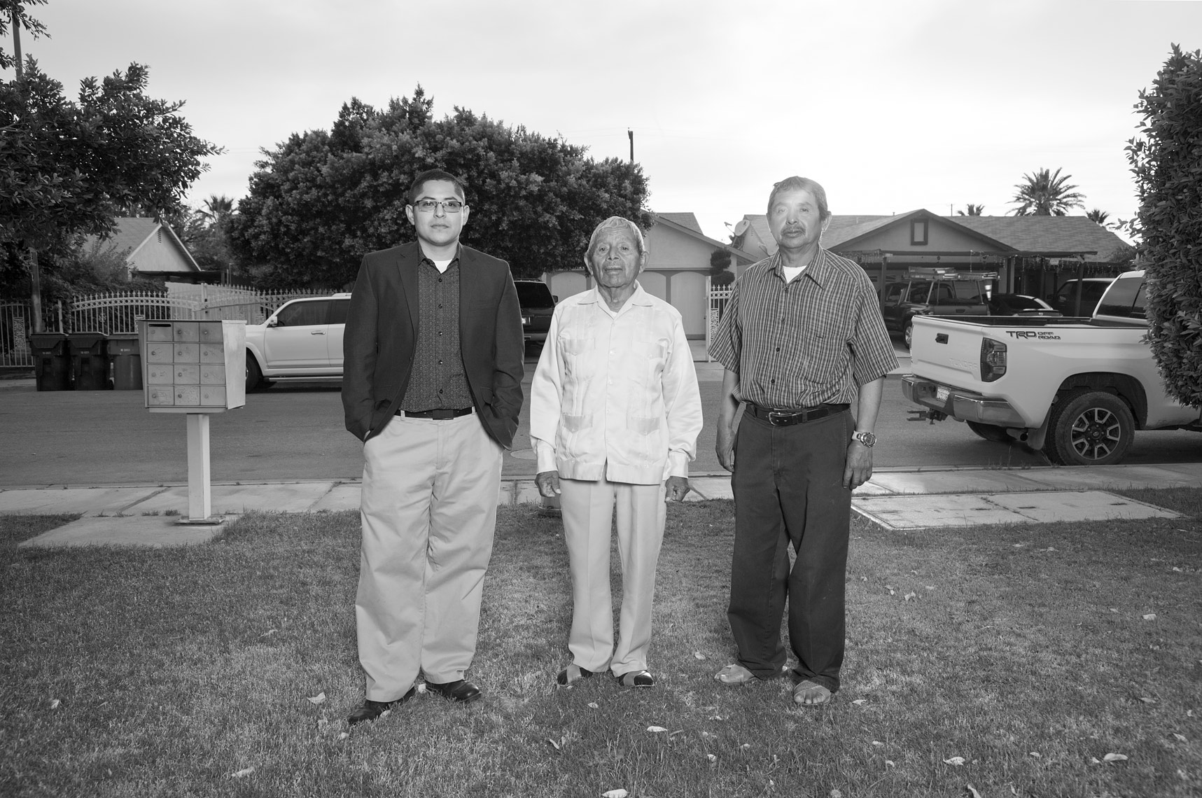 Castulo, Onesimo and Jeronimo Estrada standing in front of their family home in Coachella, Ca.
