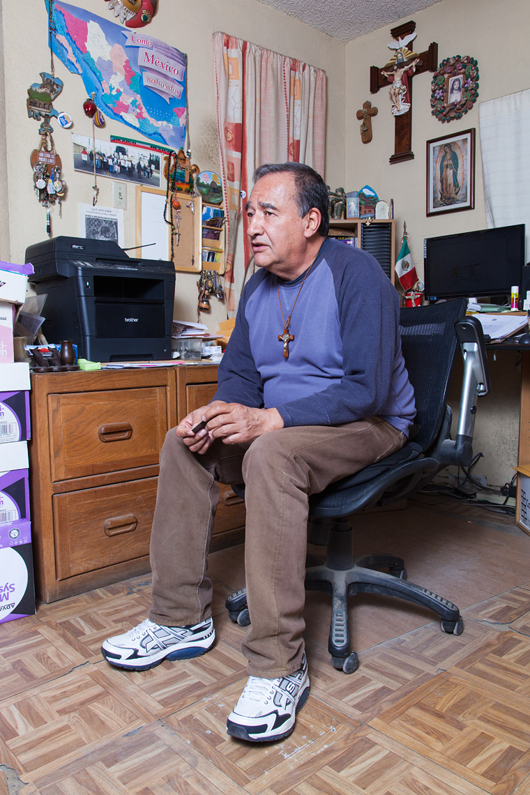 Jose Mario Lazcano speaking to clients in his office.